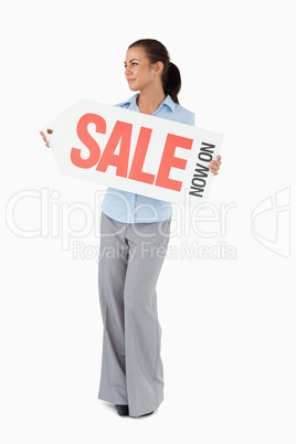 Businesswoman holding sign in front of her