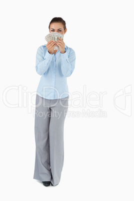 Businesswoman smelling banknotes