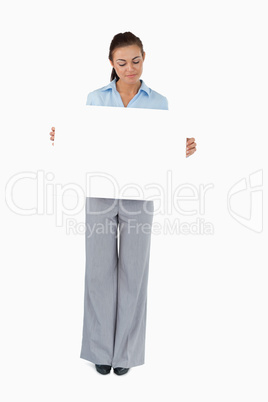 Businesswoman looking at the sign she is presenting