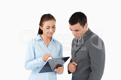 Businesswoman showing data to her partner
