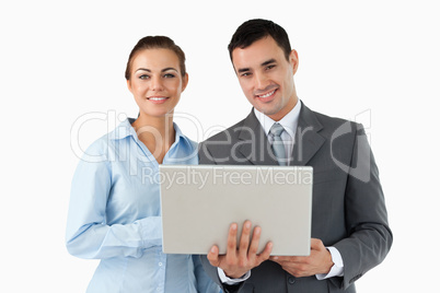 Smiling business partners with laptop
