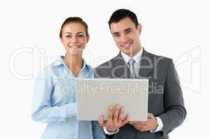 Smiling business partners with laptop