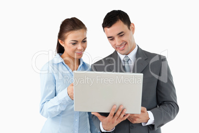 Business partners looking at laptop together