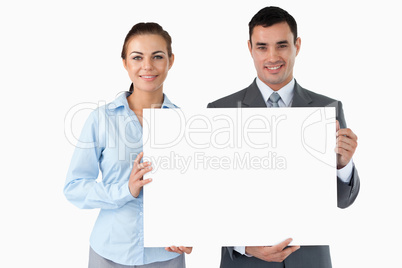 Business partners presenting sign