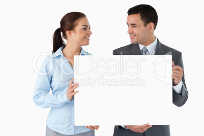 Young business partners presenting sign