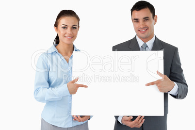 Business partners presenting sign together