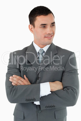 Businessman with arms folded looking to the side