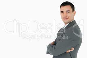 Side view of businessman with arms folded looking to the side