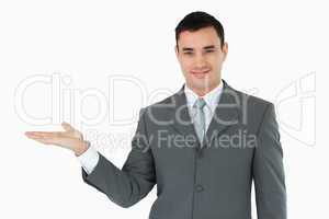 Businessman presenting something in his palm
