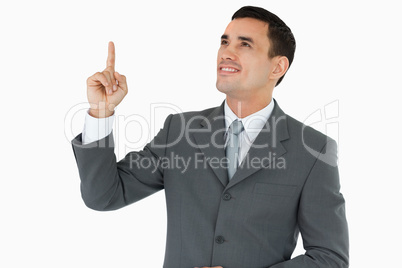 Businessman looking and pointing upwards