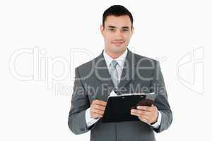 Businessman with clipboard and pen