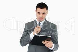 Businessman with pen and clipboard