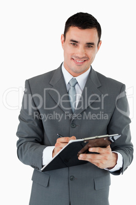 Smiling businessman taking notes