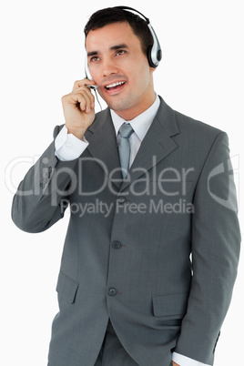 Male call center agent looking upwards while talking