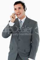 Male call center agent looking upwards while talking