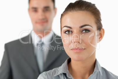 Close up of young businesswoman with colleague behind her