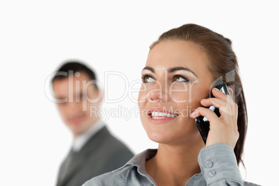 Close up of smiling businesswoman on the phone with colleague be