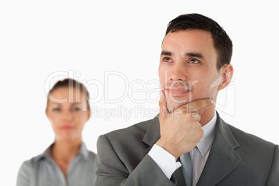 Close up of thinking businessman with colleague behind him
