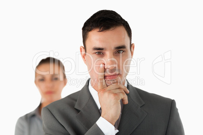 Close up of young businessman with colleague behind him