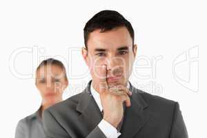 Close up of young businessman with colleague behind him