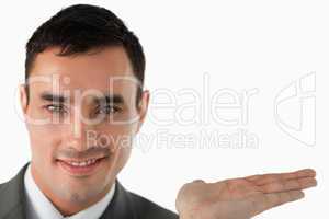 Close up of businessman presenting something in his palm