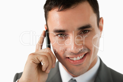 Close up of smiling businessman on his phone