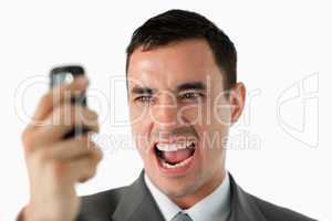 Close up of businessman upset about text message
