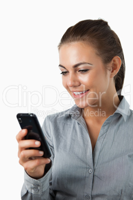 Close up of smiling businesswoman reading text message