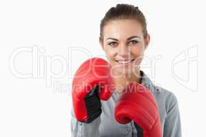 Smiling businesswoman with boxing gloves