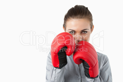 Young businesswoman with boxing gloves