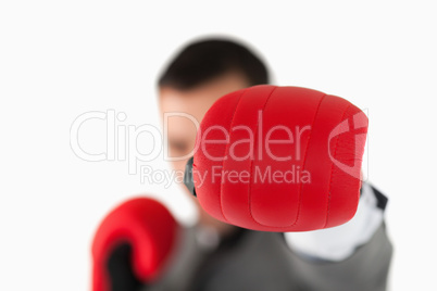 Close up of boxing glove being used to slam by businessman