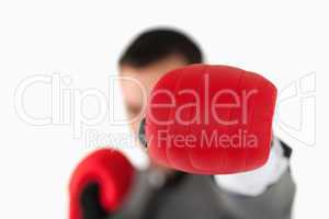 Close up of boxing glove being used to slam by businessman