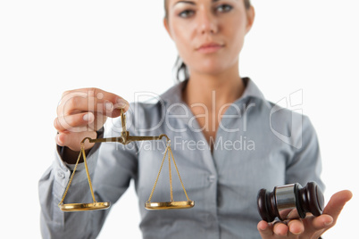 Scale and gavel being held by female lawyer