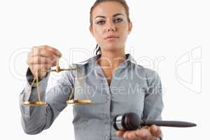 Female lawyer holding scale and gavel