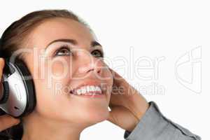 Close up of young businesswoman listening to music