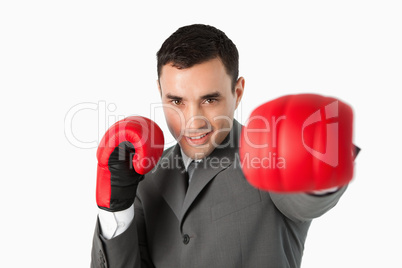 Businessman with boxing gloves on beating