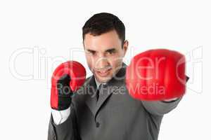 Businessman with boxing gloves on beating