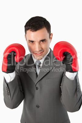 Close up of smiling businessman with boxing gloves on