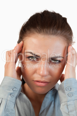 Close up of young businesswoman suffering from a headache