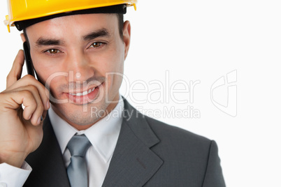 Close up of confident smiling architect on the phone