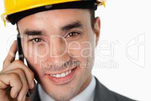 Close up of smiling architect speaking on the phone