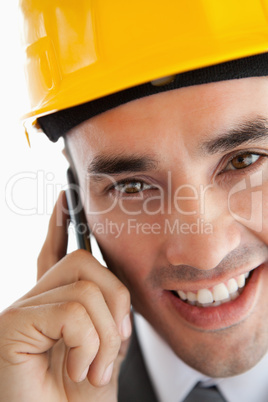 Close up of smiling architect listening to customer on the phone