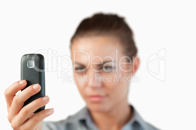 Close up of cellphone being held by businesswoman