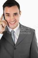 Close up of friendly smiling businessman on the phone