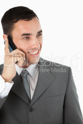 Close up of smiling businessman looking to the side while on the