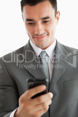 Close up of businessman writing text message on his phone