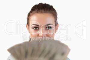 Close up of businesswoman showing bank notes