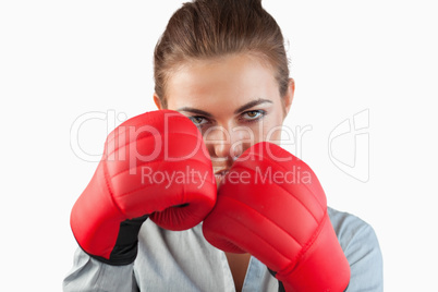 Close up of serious businesswoman with boxing gloves