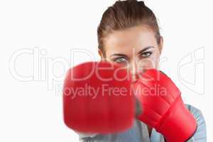 Close up of businesswoman striking with boxing gloves