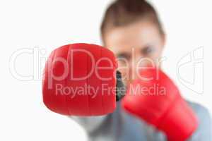 Close up of boxing glove used by businesswoman
